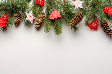 Fototapeta na wymiar Christmas toys with fir tree branches on white background, copy space
