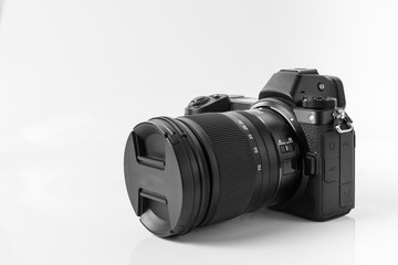Mirroless full frame camera, with 14-24 mm lens attached. White backgroundMirroless full frame...