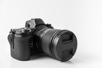 Mirroless full frame camera, with 24 - 70 mm lens attached. White background
