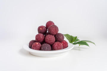 Sweet and sour red fruit bayberry, before a white color background
