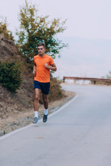 Healthy running runner man workout on mountain road