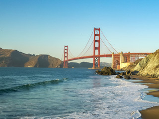 sunset view of golden gate bridge from marshall beach in san francisco