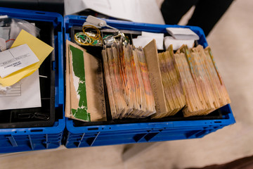 Stacks of banknotes placed into a plastic box