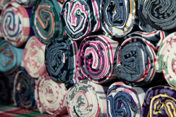 Pile of Loincloth fabric Thailand silk. Thai loincloth roll for sale at the market in thailand