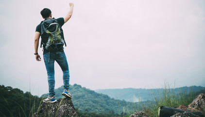 Winner and success Hiking concept. hiker celebrating success on top of a mountain