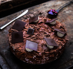 Black forest cake filled with cherries on a rustic surface