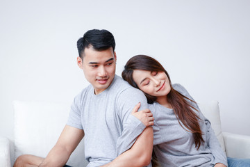 Asian lovers live together happily in the living room at home.