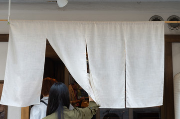 The curtain-like fabric that hangs in front of traditional Japanese restaurants and shops not only serves as a signboard, but holds a larger meaning,