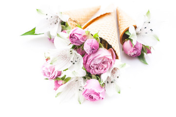 Wedding decoration. Bouquets of flowers in waffle cones on a white background. Rose and alstrameria. Theme for greeting cards or wedding invitations.