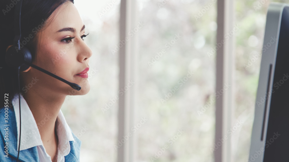 Aufkleber customer support agent or call center with headset works on desktop computer while supporting the cu