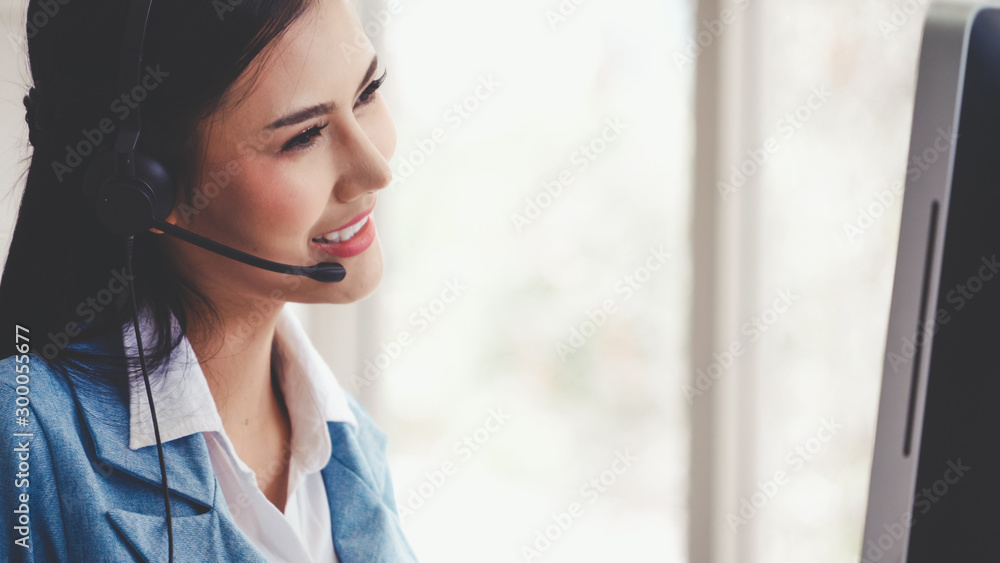 Aufkleber customer support agent or call center with headset works on desktop computer while supporting the cu