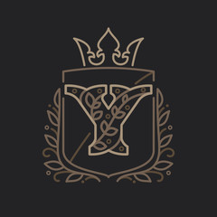 Y letter logo consisting of floral pattern letters in a heraldic shield with crown.