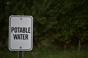 Potable Water sign with trees in background