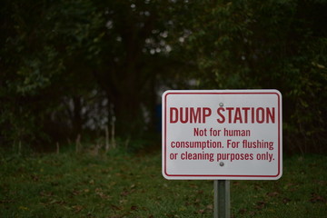 Dump Station sign with trees in background