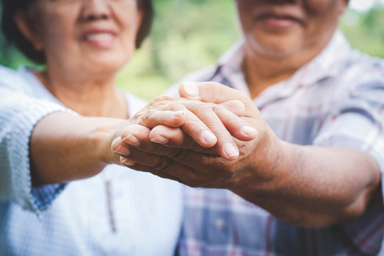 Elderly Lovers Holding Hands Dancing In The Garden Have Fun In Retirement Life. Senior Community Concepts