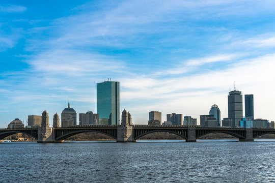 Scene of Train running over the Longfellow Bridge the charles river at the evening time, USA downtown skyline, Architecture and building with transportation concept