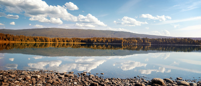 Beautiful landscape, the shore of Lake Snasa in Norway, soft focus through the flowers