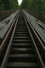 Fototapeta premium Train track on the historic iron railway bridge - Pilchowice Lake - Lower Silesia, Poland. industrial abstraction.