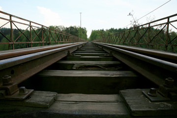 Fototapeta premium Train track on the historic iron railway bridge - Pilchowice Lake - Lower Silesia, Poland. industrial abstraction.