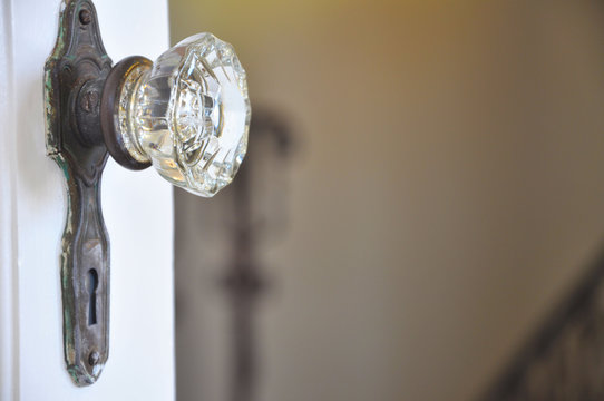 Vintage Decorative Clear Door Knob On A White Door.