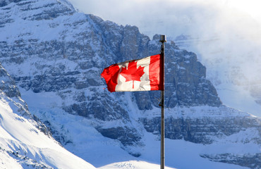 Canadian national flag is shining in Canadian rocky mountains at Banff National Park,Alberta,Canada