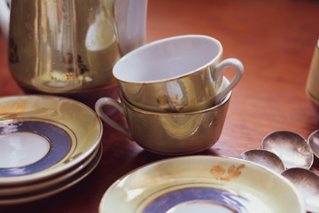 Vintage dishes, saucers, cups, sugar bowl, milk jug and spoons