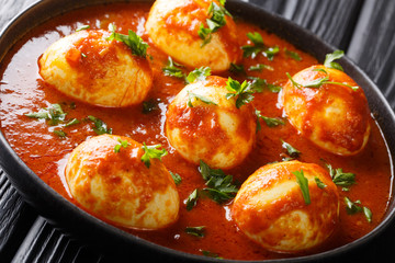 Curry egg recipe in spicy sauce close-up in a plate. horizontal