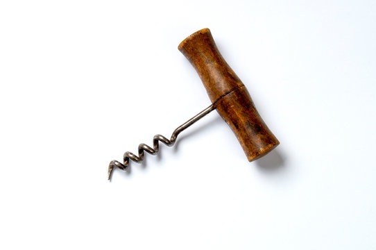 vintage corkscrew on white background, handle to the right tip to the left