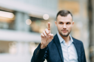 Naklejka premium Holds and shows direction and presentation. Hand and finger of a business man in the office, profit growth.