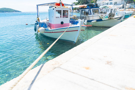 Traditional  Greek fishing boats moored along Old Port pier