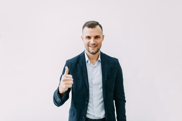 Success and luck in work, respect. Portrait of a young successful man with emotions.