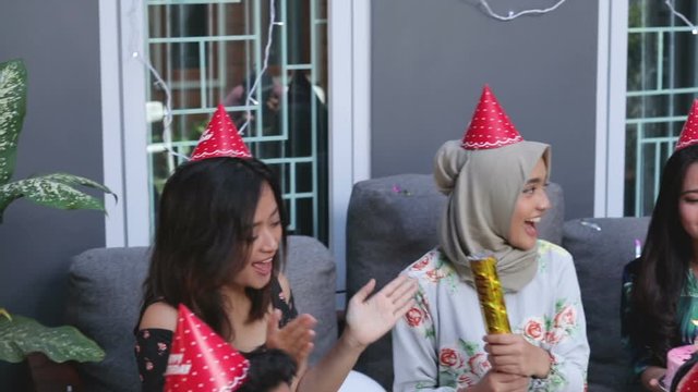 Group of friends enjoying brithday party and singing together