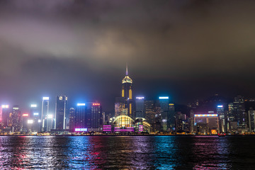 August 10,2019 in Hong Kong, Scenic of night cityscape light show and water reflection and cloudy in the sky background ,blurred of fog and clouds dark 