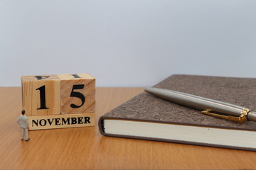 November  15, a calendar photo from the wood The table top consists of a book and pen that is ready...