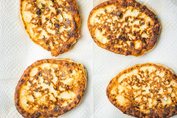 Curd cheesecakes on white napkin to absorb excess oil.