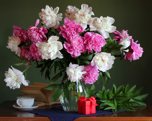 lush bouquet of white and pink peonies on the table.