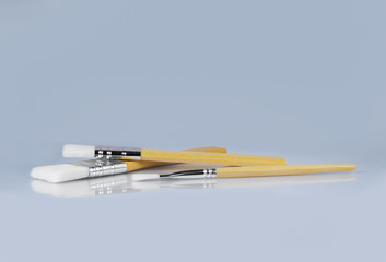 Paint brushes on gray background, front view