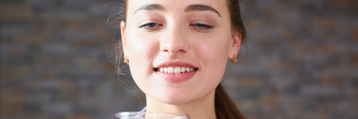 Beautiful woman hold in arms glass of red wine