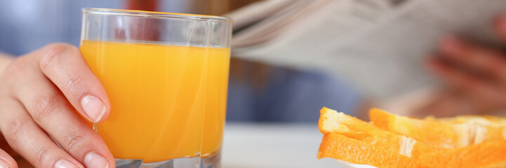 Beautiful woman hold in arms glass of orange juice