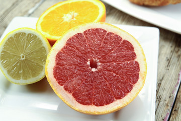 Naklejka na ściany i meble citrus fruits, oranges, grapefruit and lemon on a table