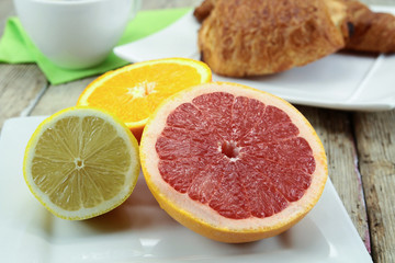 citrus fruits, oranges, grapefruit and lemon on a table