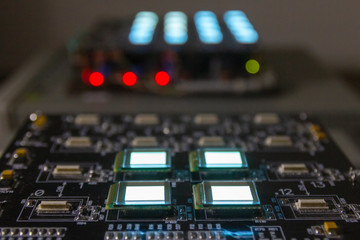 The process of checking several oled displays of white color on the test station. Displays glow...