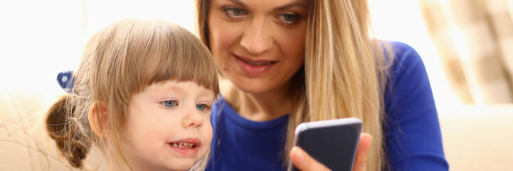 Cute little girl on floor carpet with mom