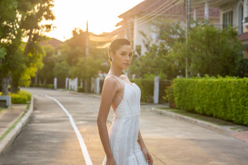 Portrait of Beautiful woman trying on bridal gown in studio