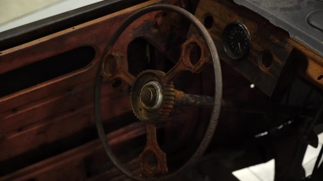 Old rusty car interior. Steering wheel and dashboard
