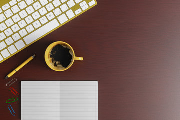 Home office desk with notebook, yellow pen, yellow keyboard and yellow cup of coffee on red wood table. Top view flat lay with copy space.