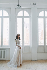 Fototapeta premium Beautiful girl in white dress, European wedding. Air and light photo shoot of the bride.