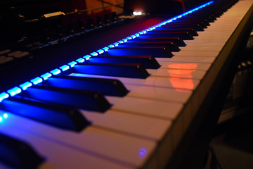 Angled close up on synthesizer keyboard keys