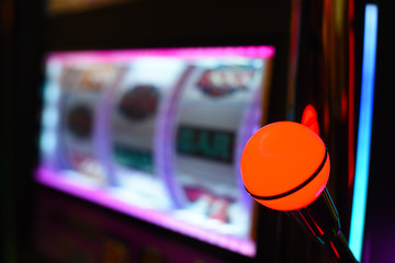close up on pull handle of a casino gambling slot machine