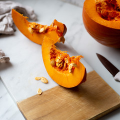 pumpkins with cinnamon sticks on marble backgrund